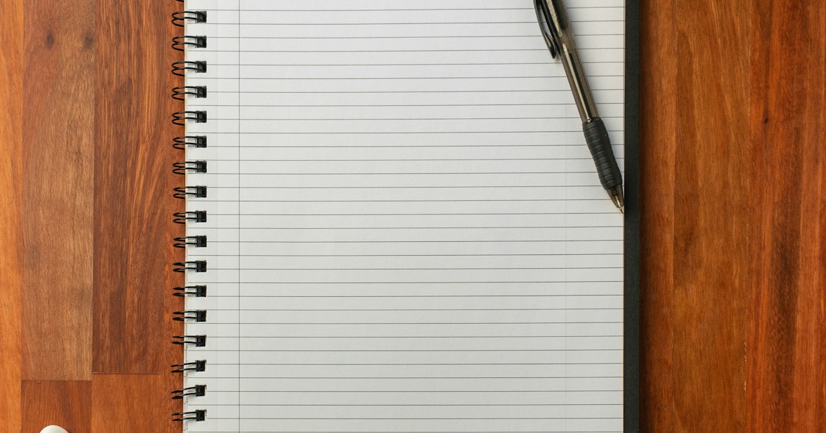 Consultant outlining service packages in a notebook