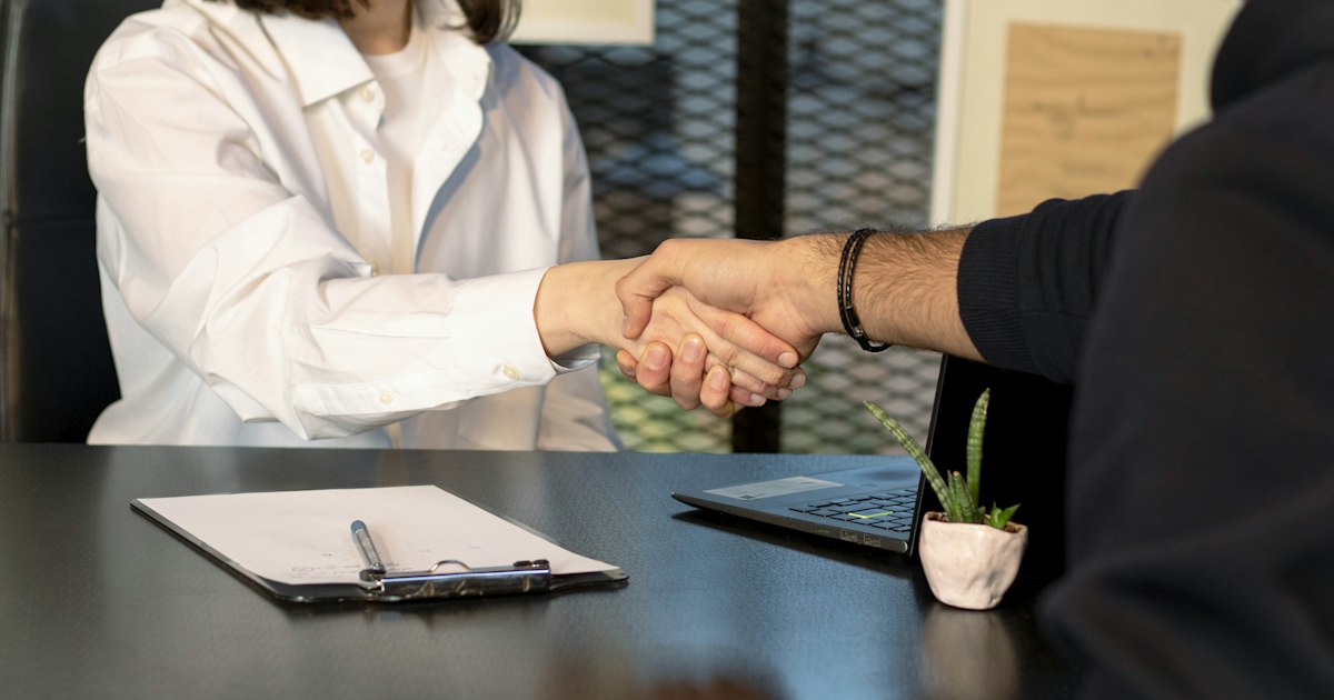 Consultant shaking hands with their first client