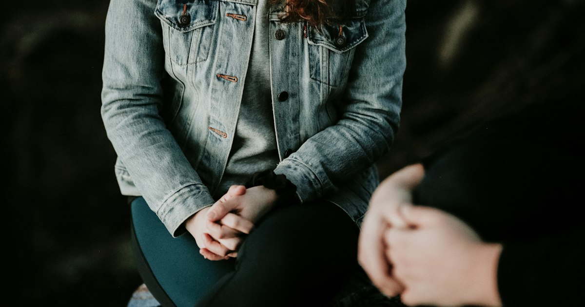 A person talking to a therapist online